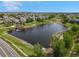 Enjoy this beautiful aerial view showcasing a pond with docks and gazebo surrounded by lush trees at 7380 S Shady Grove Way, Aurora, CO 80016