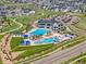 Aerial view of the community clubhouse, pool, playground, and parking area; beautiful manicured green space at 7380 S Shady Grove Way, Aurora, CO 80016