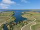 Beautiful aerial shot featuring a long lake with winding paths, trees, and open green spaces at 7380 S Shady Grove Way, Aurora, CO 80016