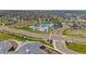 An aerial view showcases the community pool and clubhouse amidst a neighborhood and green spaces at 7380 S Shady Grove Way, Aurora, CO 80016