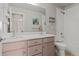 Bathroom features a double sink vanity, large mirror, and shower-tub combination with white tile surround at 7380 S Shady Grove Way, Aurora, CO 80016