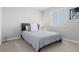 Cozy bedroom featuring a comfortable bed with stylish headboard and bright natural light from the window at 7380 S Shady Grove Way, Aurora, CO 80016