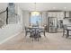 Open dining room with a view of staircase, modern lighting, and stainless steel appliances at 7380 S Shady Grove Way, Aurora, CO 80016