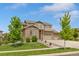 Two-story brick home showcasing a well-manicured lawn, mature trees, and a spacious driveway at 7380 S Shady Grove Way, Aurora, CO 80016