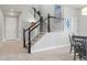 Bright foyer featuring a staircase with decorative art, an open floor plan, and access to living areas at 7380 S Shady Grove Way, Aurora, CO 80016