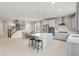Open concept kitchen featuring a large island, modern appliances, and seamless access to the dining area at 7380 S Shady Grove Way, Aurora, CO 80016