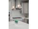 Updated kitchen features grey cabinets, a gas range, stainless steel appliances, and a center island at 7380 S Shady Grove Way, Aurora, CO 80016