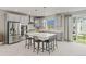 Bright kitchen features grey cabinets, stainless appliances, and a large island with seating at 7380 S Shady Grove Way, Aurora, CO 80016