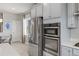 Shows stainless steel refrigerator, built-in oven, and gray cabinets at 7380 S Shady Grove Way, Aurora, CO 80016