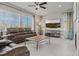 Inviting living room featuring large windows, a ceiling fan, comfortable seating and tile floors at 7380 S Shady Grove Way, Aurora, CO 80016