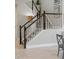 Elegant staircase features dark wood railings, white balusters, and plush gray carpeting at 7380 S Shady Grove Way, Aurora, CO 80016