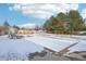 Winter view of backyard in-ground pool with safety cover and slide at 221 Mulligan Lake Dr, Mead, CO 80542