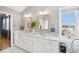 Elegant bathroom with double vanity and marble countertops at 221 Mulligan Lake Dr, Mead, CO 80542