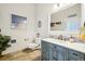 Powder room with teal vanity and decorative mirror at 221 Mulligan Lake Dr, Mead, CO 80542