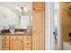 Bathroom with light wood cabinets and granite countertop at 221 Mulligan Lake Dr, Mead, CO 80542