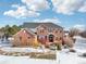 Brick home with a large yard; winter scene at 221 Mulligan Lake Dr, Mead, CO 80542