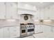 Modern kitchen featuring stainless steel appliances and white cabinetry at 221 Mulligan Lake Dr, Mead, CO 80542