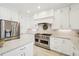 Bright kitchen with stainless steel appliances and white cabinets at 221 Mulligan Lake Dr, Mead, CO 80542