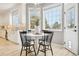 Modern kitchen with white cabinets and eat-in area at 221 Mulligan Lake Dr, Mead, CO 80542