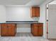 Basement kitchenette with wood cabinetry, a sleek countertop, and a convenient sink at 2252 S Yosemite Cir, Denver, CO 80231