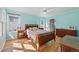 Bright bedroom with hardwood floors, windows, and a ceiling fan creates a relaxing atmosphere at 2252 S Yosemite Cir, Denver, CO 80231
