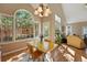 Cozy dining area with large windows and ample natural light is adjacent to the open living room at 2252 S Yosemite Cir, Denver, CO 80231