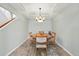 Traditional dining room with an oval wood table, seating for four, and elegant chandelier lighting at 2252 S Yosemite Cir, Denver, CO 80231