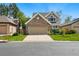 Exterior view of home with brick facade, two-car garage, and well-manicured lawn at 2252 S Yosemite Cir, Denver, CO 80231