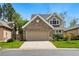 Charming two-story home features a brick facade and a two-car garage with a well-manicured lawn at 2252 S Yosemite Cir, Denver, CO 80231