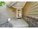 Inviting front porch with secure storm door, brick accents, and stone landscape elements at 2252 S Yosemite Cir, Denver, CO 80231