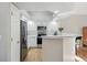 Well-lit kitchen featuring white cabinets, stainless steel appliances, and a breakfast bar with seating at 2252 S Yosemite Cir, Denver, CO 80231