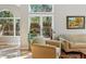 Sun-drenched living area with hardwood floors, large windows, and an inviting seating area at 2252 S Yosemite Cir, Denver, CO 80231