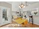 Open concept living area with vaulted ceilings, fireplace, and access to the kitchen and outdoor patio at 2252 S Yosemite Cir, Denver, CO 80231