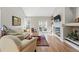 Relaxing living room with a fireplace, hardwood floors, and access to the backyard through French doors at 2252 S Yosemite Cir, Denver, CO 80231