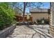 Backyard patio area with seating and lush landscaping, creating a serene outdoor space at 2252 S Yosemite Cir, Denver, CO 80231
