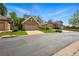 Street view of home with brick facade, well-manicured lawn, and paved driveway at 2252 S Yosemite Cir, Denver, CO 80231
