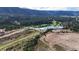 Stunning aerial view featuring a serene lake, golf course, surrounding forests, and rolling hills at 7113 Echo Hills Club Rd, Larkspur, CO 80118