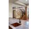 Close-up of a bar area featuring a dark countertop and a copper sink, with a view of the custom staircase at 7113 Echo Hills Club Rd, Larkspur, CO 80118