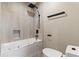 Bright bathroom features a tub and shower with black fixtures, next to a low-profile toilet at 7113 Echo Hills Club Rd, Larkspur, CO 80118