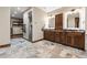 Bathroom featuring double vanities, stone floors, and a glass shower at 7113 Echo Hills Club Rd, Larkspur, CO 80118