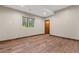 Unfurnished room features hardwood floors, a wood door and base trim, and one window at 7113 Echo Hills Club Rd, Larkspur, CO 80118