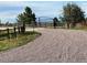 Gravel driveway leading to a gated property with fenced boundaries, offering privacy and security at 7113 Echo Hills Club Rd, Larkspur, CO 80118