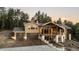 Elegant two-story home featuring a two-car garage, stone accents, and a covered porch with wooden beams at 7113 Echo Hills Club Rd, Larkspur, CO 80118