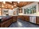 Gourmet kitchen featuring professional-grade range, stainless steel appliances, and custom cabinetry at 7113 Echo Hills Club Rd, Larkspur, CO 80118