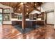 Open concept kitchen with custom wood cabinets, stone countertops, and a spacious island at 7113 Echo Hills Club Rd, Larkspur, CO 80118