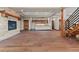Cozy living room featuring a stone fireplace, dark wood floors, and custom wood cabinets and shelves at 7113 Echo Hills Club Rd, Larkspur, CO 80118