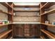 Walk-in pantry with custom shelving and cabinets providing ample storage space at 7113 Echo Hills Club Rd, Larkspur, CO 80118