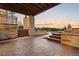 Covered patio with stone pillars and stamped concrete, perfect for outdoor entertaining while enjoying serene views at 7113 Echo Hills Club Rd, Larkspur, CO 80118