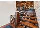 Wooden staircase with a black metal railing, showcasing modern design and craftsmanship at 7113 Echo Hills Club Rd, Larkspur, CO 80118