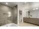 Bright bathroom features a sleek vanity, a glass-enclosed shower with gray tiling and a convenient toilet room at 1401 Delgany St # 204, Denver, CO 80202